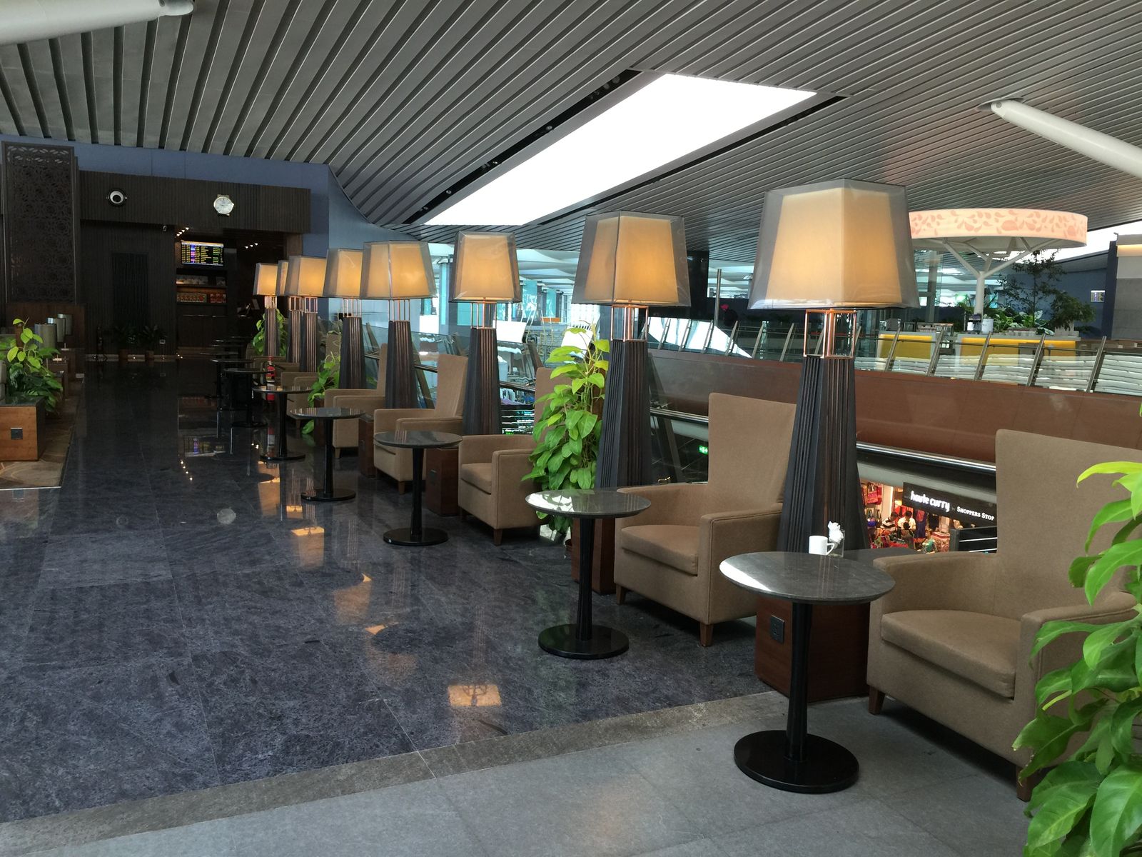 Armchairs and low tables in a quiet airport business lounge